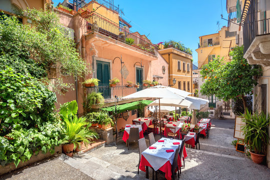 Street view with cafe in old town Taormina. Sicily, Italy