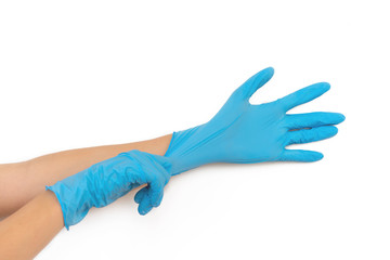 Female hands putting on blue latex gloves isolated on white