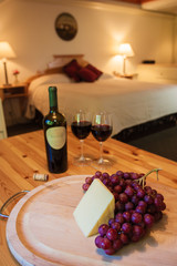 Naklejka na ściany i meble Wine and cheese in a luxurious hotel room.