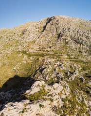 Fototapeta na wymiar Panoramic landscape. Hairpin turn road between rocky mountains. Way to Sa Calobra beach, Mallorca, Balearic Islands