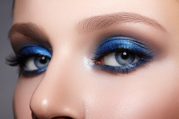 Closeup Macro of Woman Face with Blue Eyes Make-up. Fashion Celebrate Makeup, Glowy Clean Skin,...