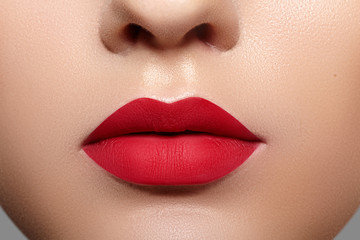 Beautiful Woman Lips with Fashion Mat Lipstick Makeup. Red Lip Make-Up Concept. Beauty Visage....