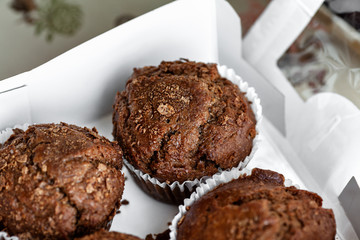 Chocolate muffins in a white paper box for morning breakfast