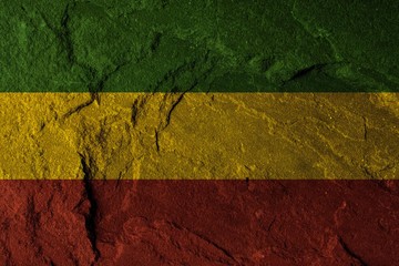 Green yellow red on stone wall, reggae background concept