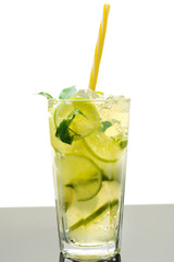 Cooling lemonade with lemon and lime, slices of ginger and mint leaves.