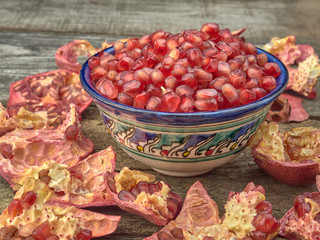 Delicious juicy red pomegranate.On wooden background