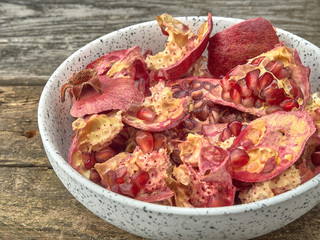 Delicious juicy red pomegranate.On wooden background