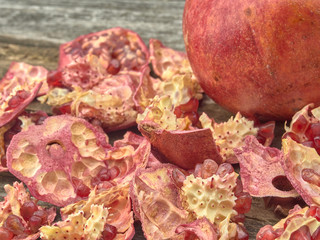 Delicious juicy red pomegranate.On wooden background