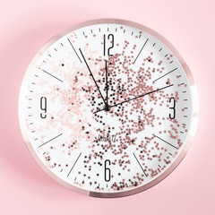 Christmas modern composition. Happy New Year. Christmas clock and stars on pastel pink background....