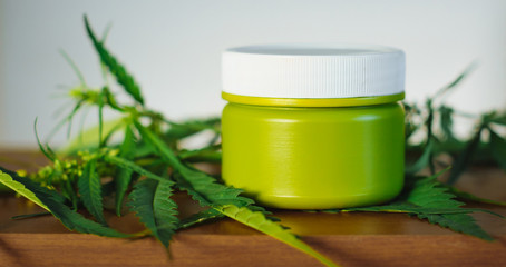 Cannabis hemp cream background with marijuana leaf - cannabis concept self care in of health care....