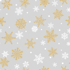 Christmas seamless pattern of complex big and small snowflakes in white and yellow colors on gray background