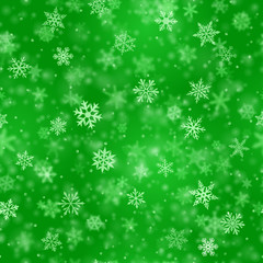 Christmas seamless pattern of complex blurred and clear falling snowflakes in green colors with bokeh effect