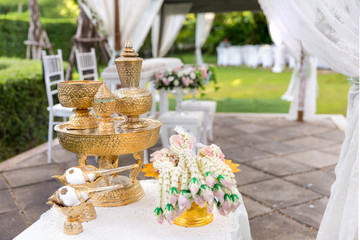 Thai wedding accessory for cultural wedding ceremony, luxury chair for bride and groom, golden tray with pedestal and the others. image for wedding objects, copy space and article.