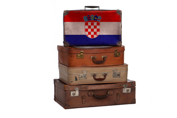Croatia, Croatian travel concept. Group of vintage suitcases isolated on white background.