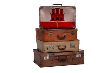Gibraltar travel concept. Group of vintage suitcases isolated on white background.