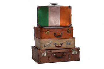 Ireland, Irish travel concept. Group of vintage suitcases isolated on white background.