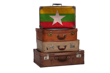 Myanmar travel concept. Group of vintage suitcases isolated on white background.