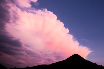 surrealistic fluffy pink cloud on blue sky - cotton candy
