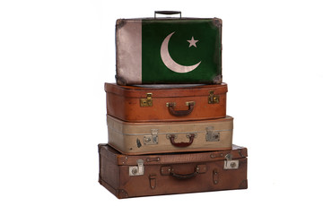 Pakistan, Pakistani travel concept. Group of vintage suitcases isolated on white background.