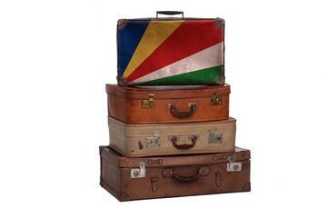 Seychelles, Seychelloise travel concept. Group of vintage suitcases isolated on white background.