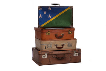 Solomon Islands travel concept. Group of vintage suitcases isolated on white background.
