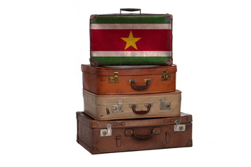Suriname, Surinamese travel concept. Group of vintage suitcases isolated on white background.