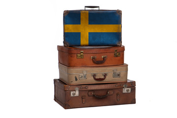 Sweden, Swedish travel concept. Group of vintage suitcases isolated on white background.