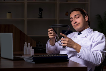 Young male doctor in the hospital at night