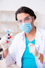 Young male chemist working in the lab