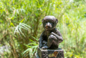 Monkey statue along the mountain road of Emei Mountain, China