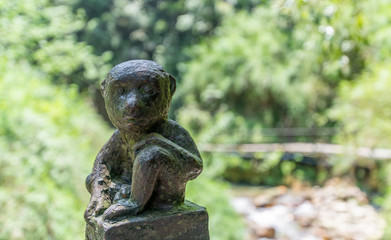 Fototapeta na wymiar Monkey statue along the mountain road of Emei Mountain, China