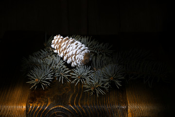 green fluffy Christmas tree, pine cone on the background of an old wooden table, rural nature, holiday cards, merry christmas and happy new year