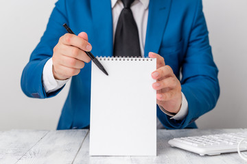 Man holds empty paper with copy space in front of him. White space for advertising message.