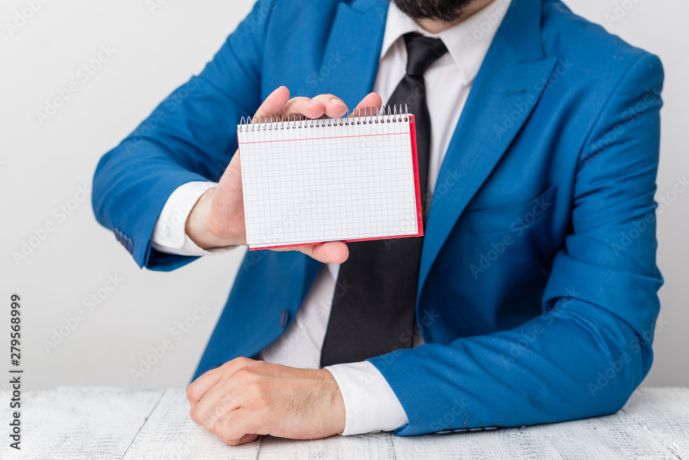 Wall mural man holds empty paper with copy space in front of him. white space for advertising message.