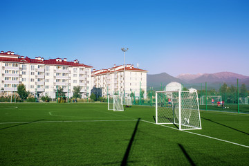 Training football field. Summer stadium and football game concept. Football field lighting. Lighting pillar with led technology. © Anton Gepolov