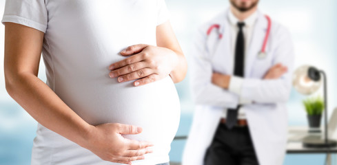 Happy pregnant woman visit gynecologist doctor at hospital or medical clinic for pregnancy...