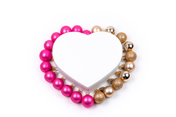 Heart shaped Christmas gift box with  pink and gold Christmas balls with  for holiday, christmas, thanks giving day, birthday.