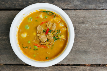 Red Curry with Pork on wooden table top view, Thai local food