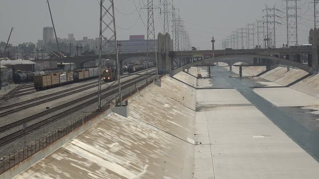 Trains run alongside the Los Angeles River in downtown LA