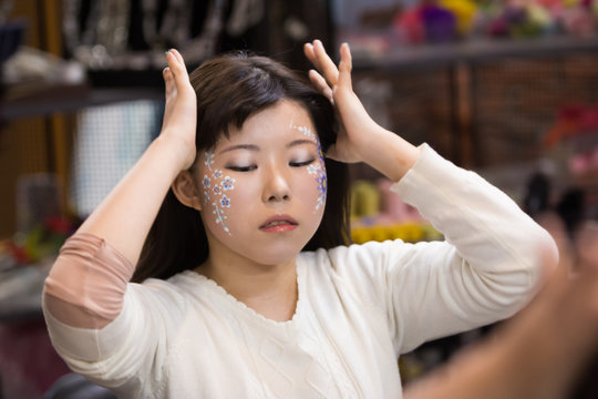 Chiba, Japan, 02/18/2019 , Japanese young model with facepaint preparing for a photo shoot.