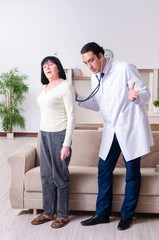 Young doctor examining senior old woman