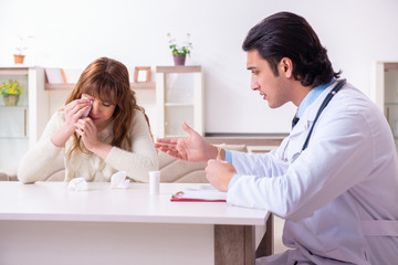 Young female patient discussing with male psychologist personal