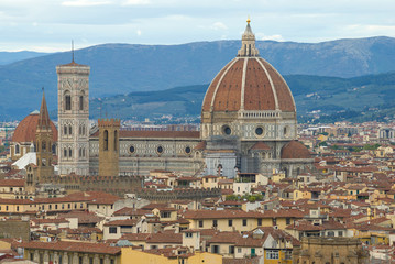 Fototapeta na wymiar Dome of Cathedral of Santa Maria del Fiore close up in a cityscape. Florence, Italy