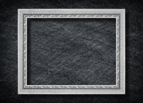Old Gray picture frame on black stone background
