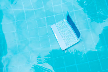 Laptop under water. Minicomputer at the bottom of the pool. The concept of obstruction at work....