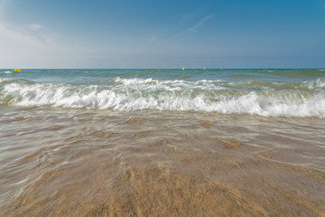 Fototapeta na wymiar Soft wave of blue sea sandy beach. Background.