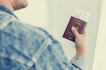 Closeup of Man holding passports and boarding pass,Business travel concept