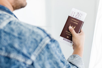 Closeup of Man holding passports and boarding pass,Business travel concept