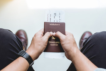 Closeup of Man holding passports and boarding pass,Business travel concept