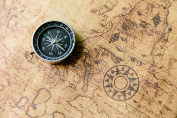 Obraz na płótnie Canvas Old compass on vintage map. Retro stale.